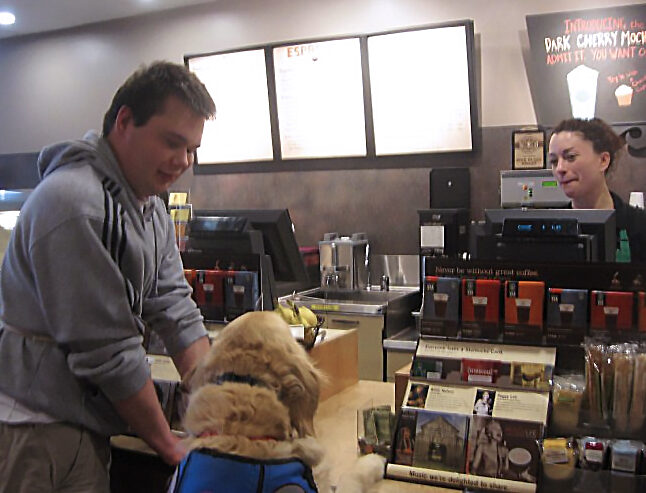 Service dog Japhy was trained to hand money to the cashier while Brendan held on to the counter.