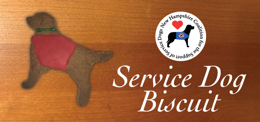 Service Dog Biscuit and the NHCSSD logo on a wooden cutting board